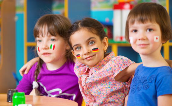 Happy children in language camp studying geography